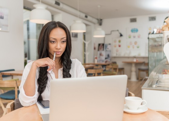 Businesswoman with laptop at cafe