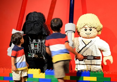Young boys look at lego-made Darth Vader (L) and Luke Skywalker (R), characters in the US movie "Star Wars" at LegoLand in Tokyo on September 15, 2013. T